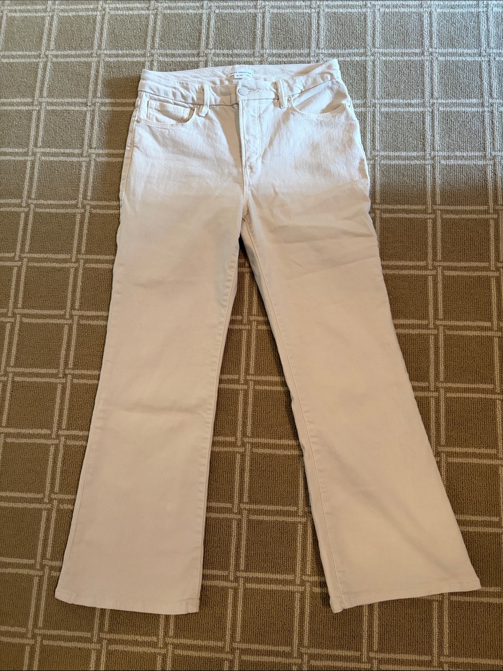 Good American cream-colored crop jeans